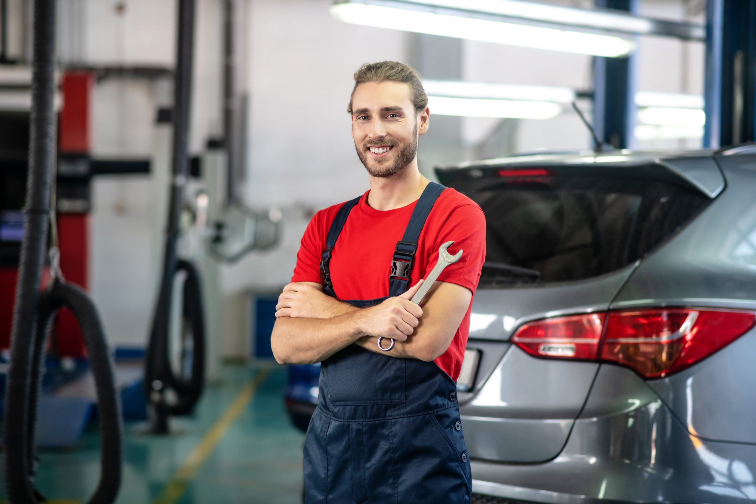 Mechanic working on a vehicle in a garage.