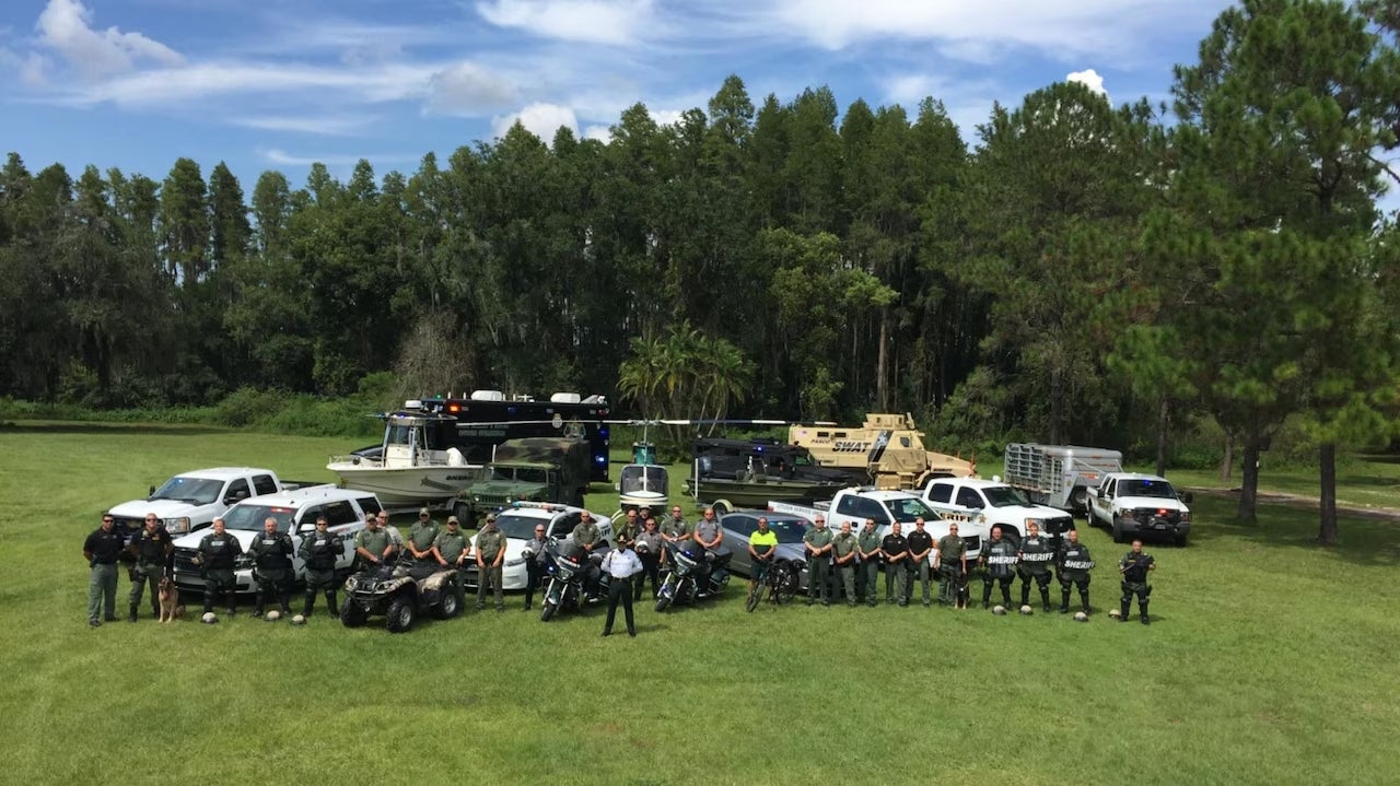 Team of people and various vehicles outdoors